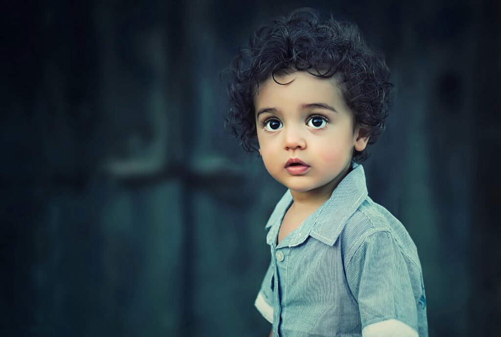 child-children-girl-happy-35537 Charming portrait of a young boy with curly hair and striking eyes.